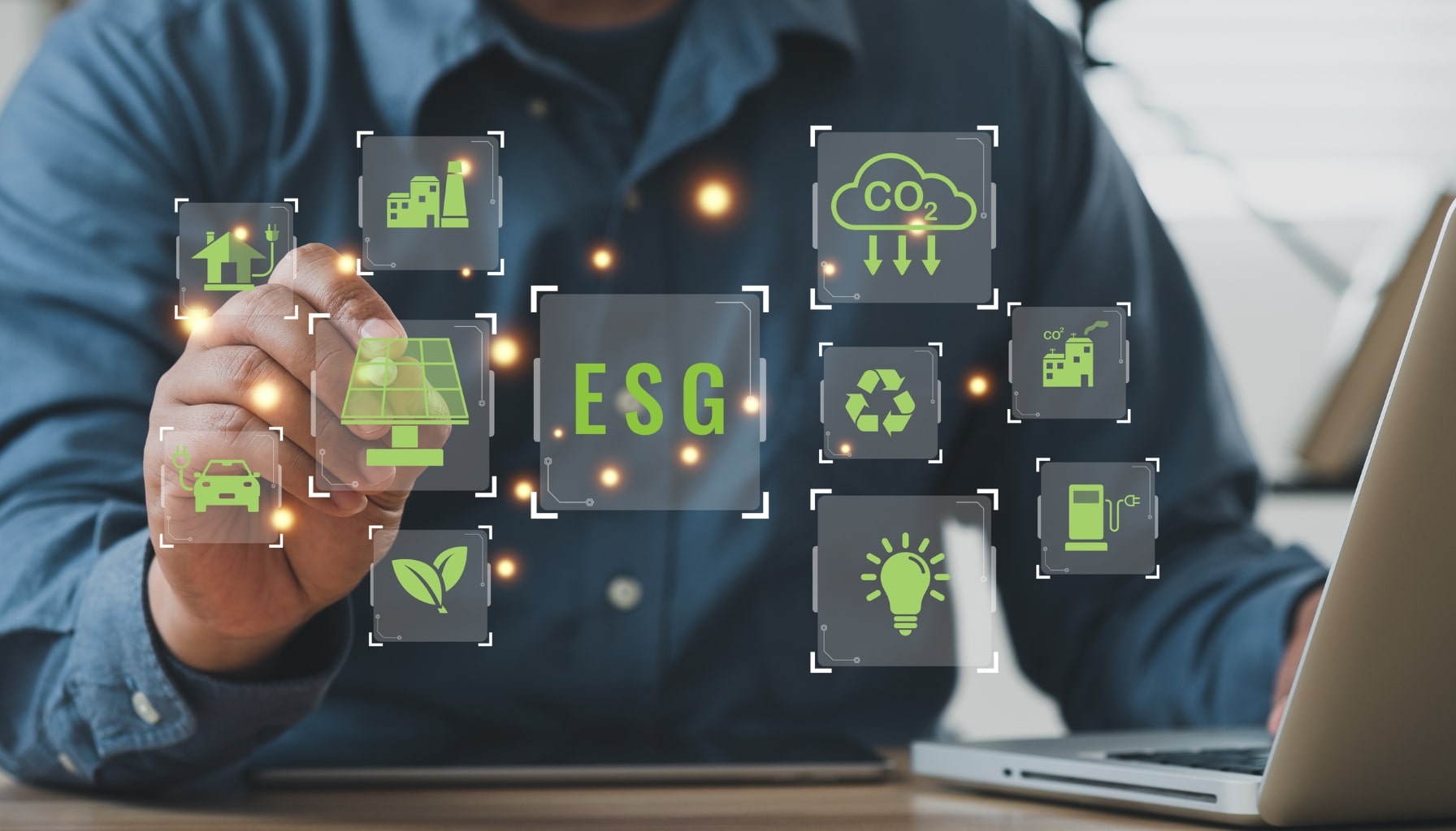 A man focused on his laptop, surrounded by eco-friendly icons representing sustainability and environmental awareness.