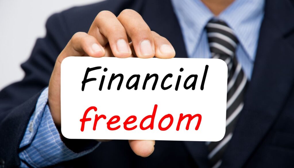 Financial Freedom' card held in hand.