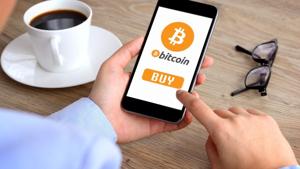 A person purchasing Bitcoin on a smartphone, showcasing the ease of digital currency transactions.