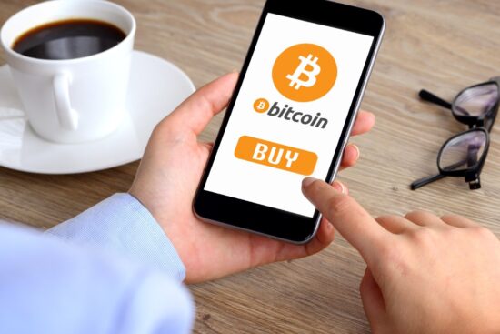 A person purchasing Bitcoin on a smartphone, showcasing the ease of digital currency transactions.