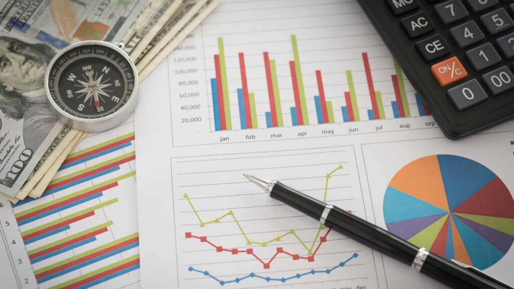 A calculator, pen, and money arranged to represent business finance and accounting concepts in a professional setting.