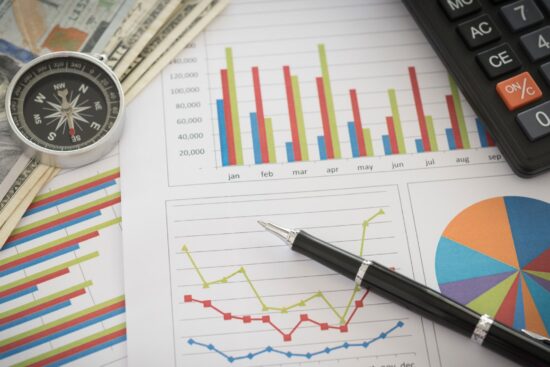 A calculator, pen, and money arranged to represent business finance and accounting concepts in a professional setting.